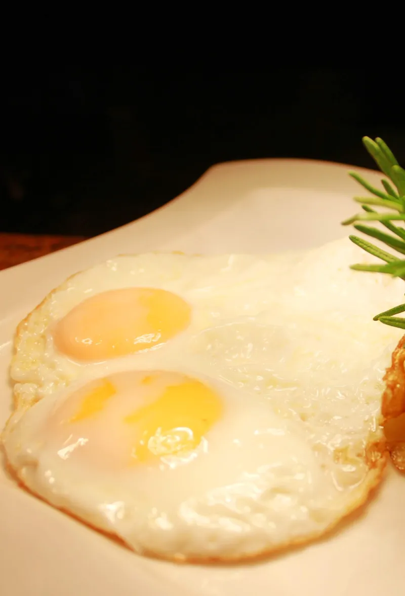 Sunny-side-up eggs with sautéed potatoes and rosemary