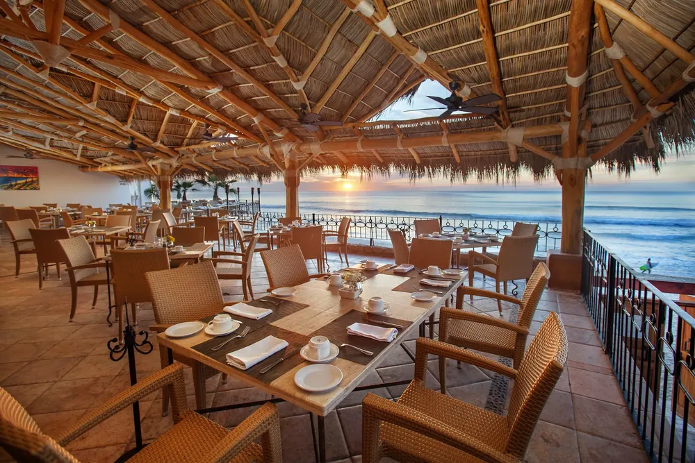 7 Seas palapa overlooking Acapulquito Beach at sunset
