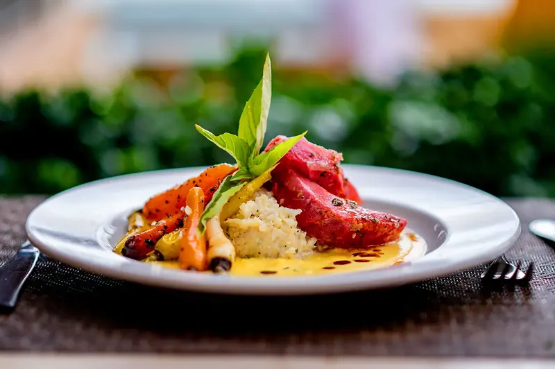 Plated seafood entrée with a bright red claw