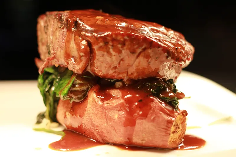 Stacked fish dish with a glossy red sauce
