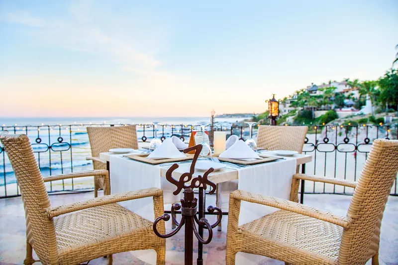 Table set beside the 7 Seas sign with an ocean view