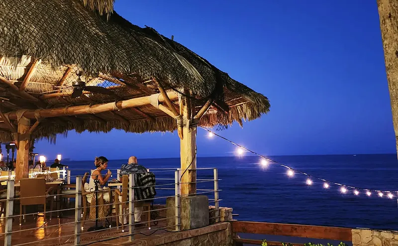 Palapa with string lights at dusk